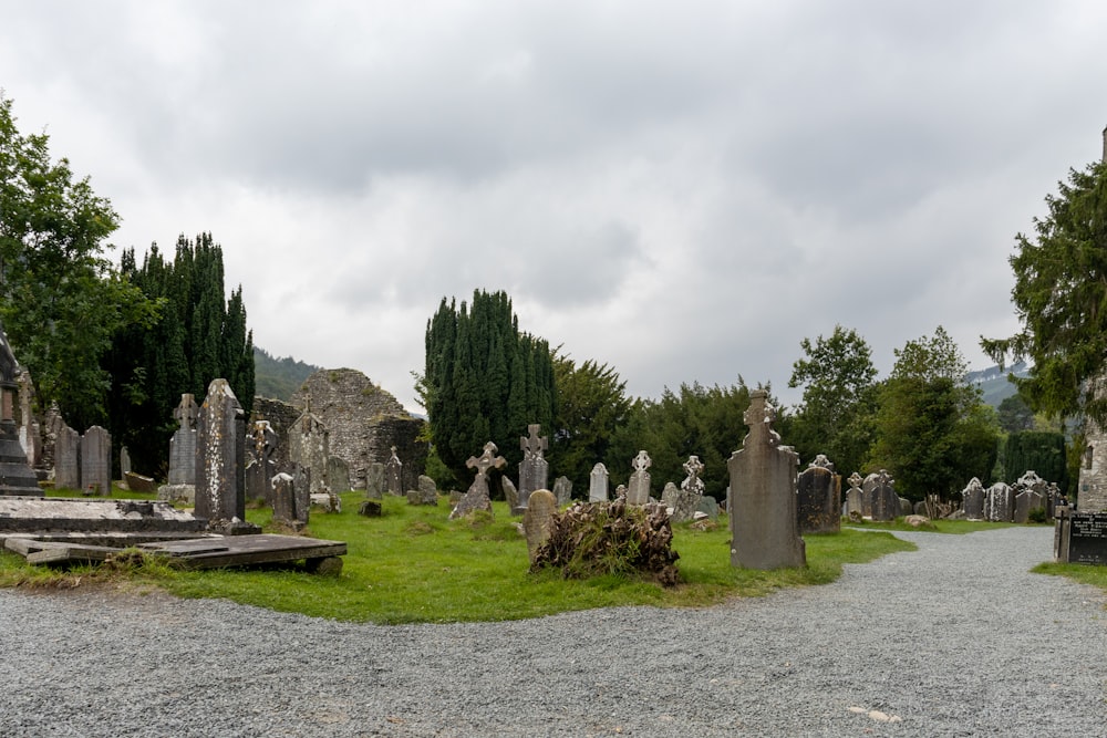 a bunch of tombstones sitting in the middle of a field