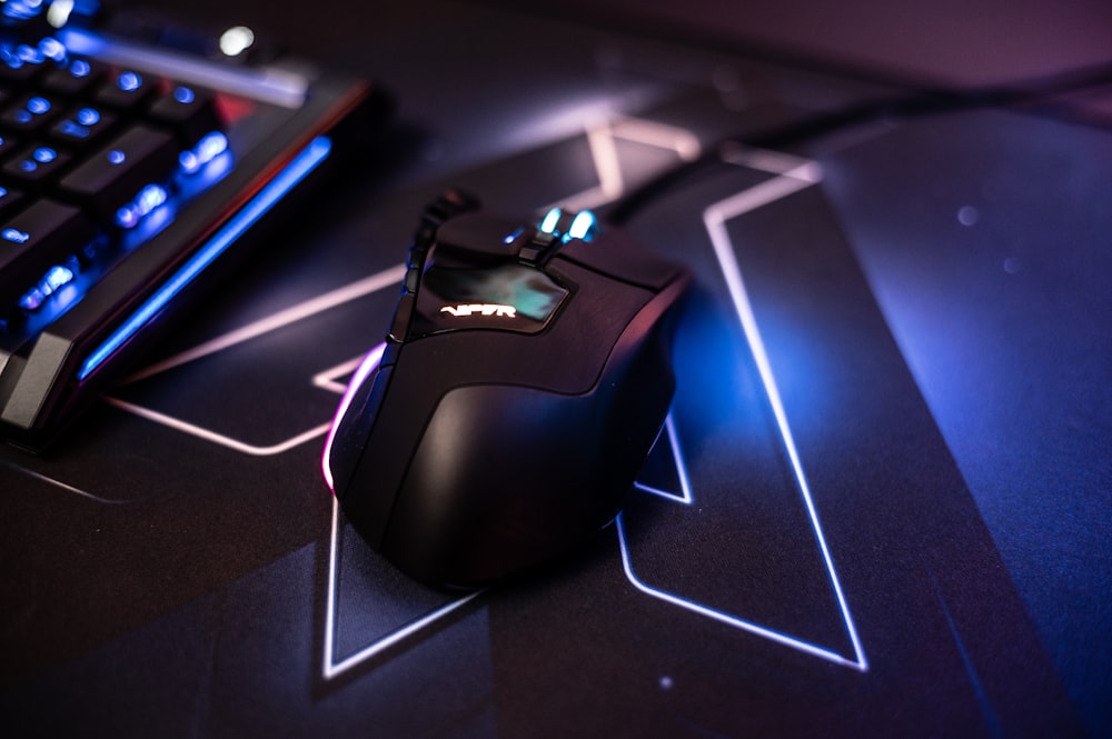 a computer mouse sitting next to a keyboard