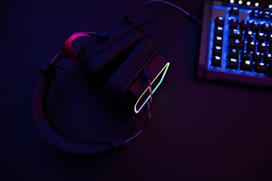 a pair of headphones sitting next to a keyboard