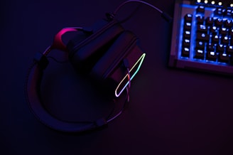 a pair of headphones sitting next to a keyboard