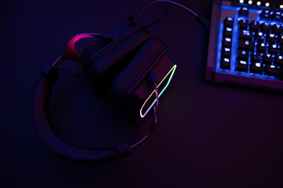 a pair of headphones sitting next to a keyboard