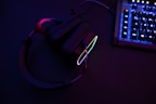 a pair of headphones sitting next to a keyboard