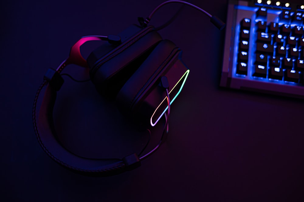 a pair of headphones sitting next to a keyboard