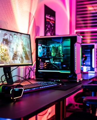 a desk with a laptop and a computer monitor