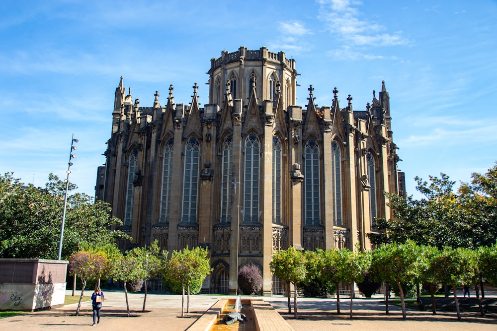 a large building with a tall tower with a clock on it's side