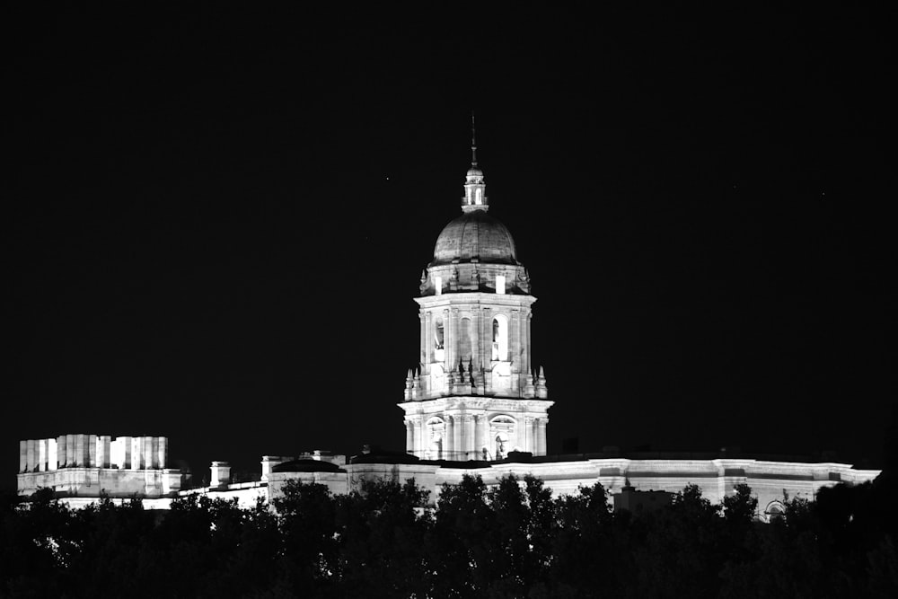 a black and white photo of a building at night