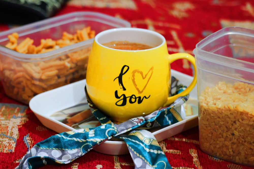 a yellow mug with i love you written on it