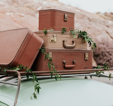 a stack of luggage sitting on top of a car