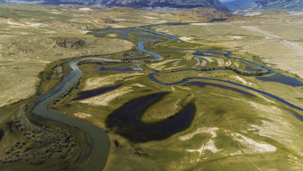 a river running through a lush green valley