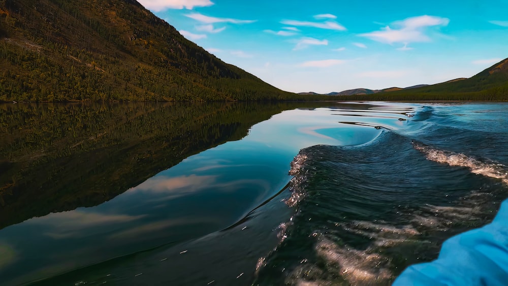 a view of a body of water with mountains in the background