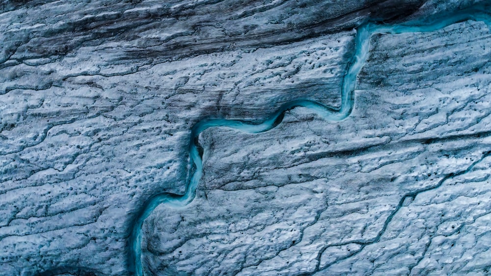 an aerial view of a river running through a glacier