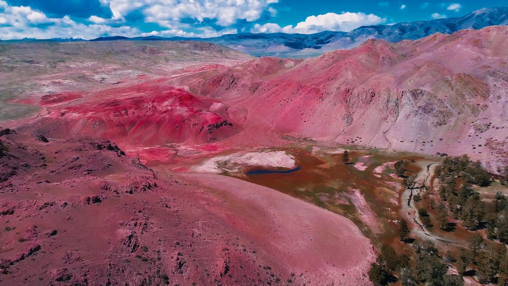 an aerial view of a mountain range with a lake in the middle