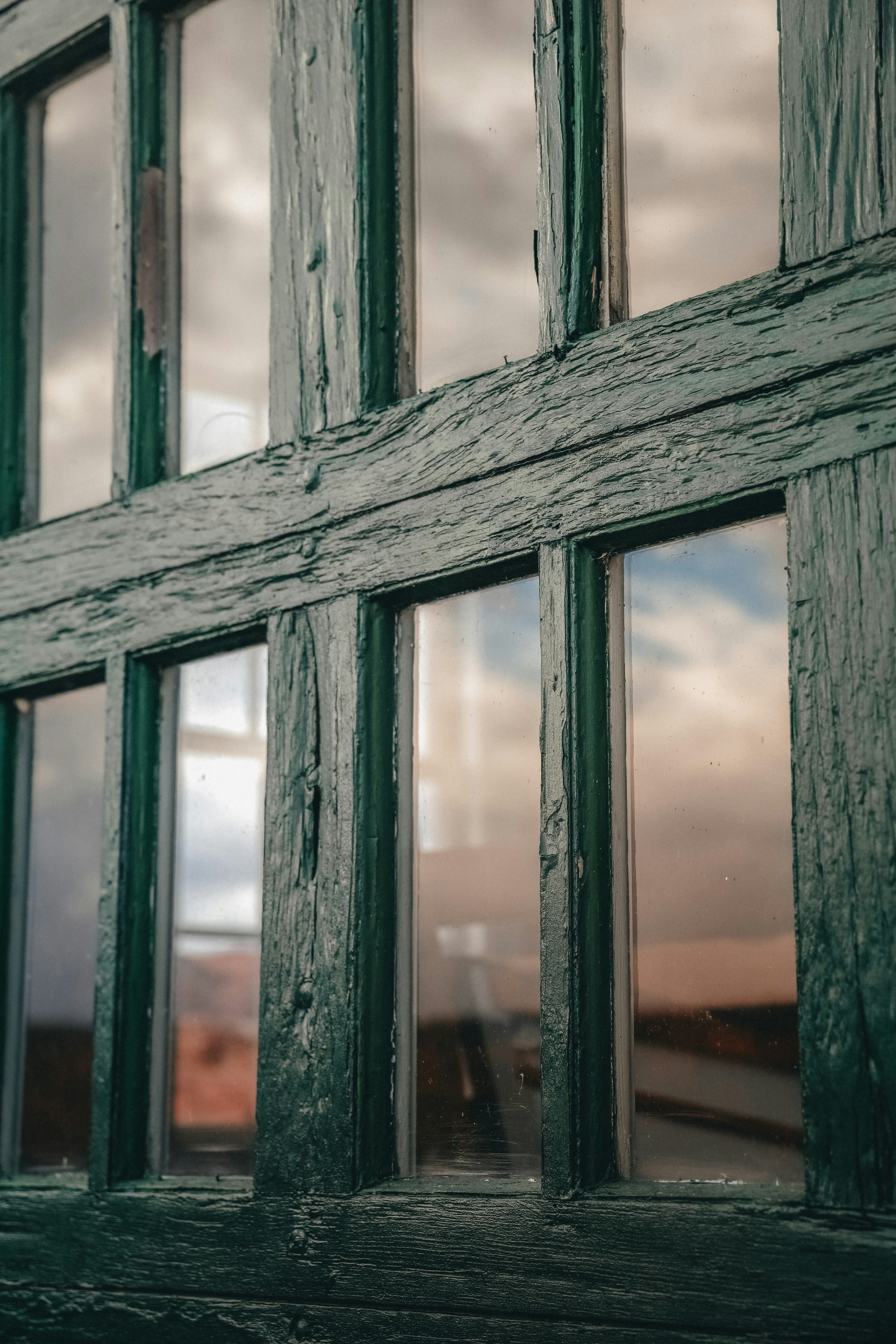 a close up of a window with a sky in the background