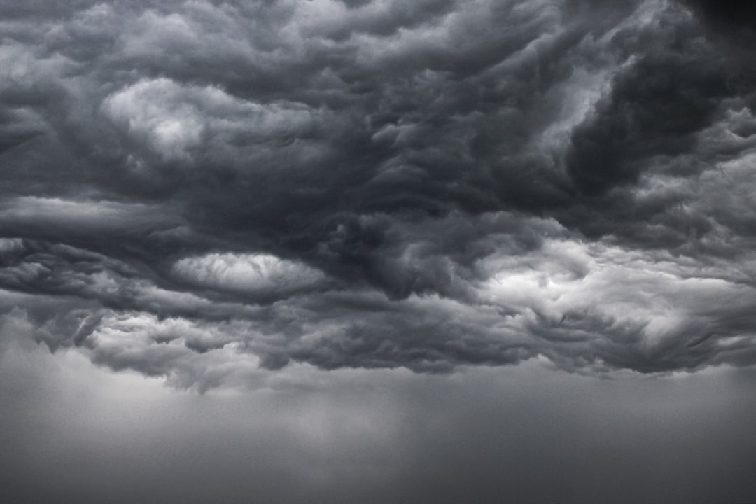 a black and white photo of storm clouds, stormy cloud vortexes