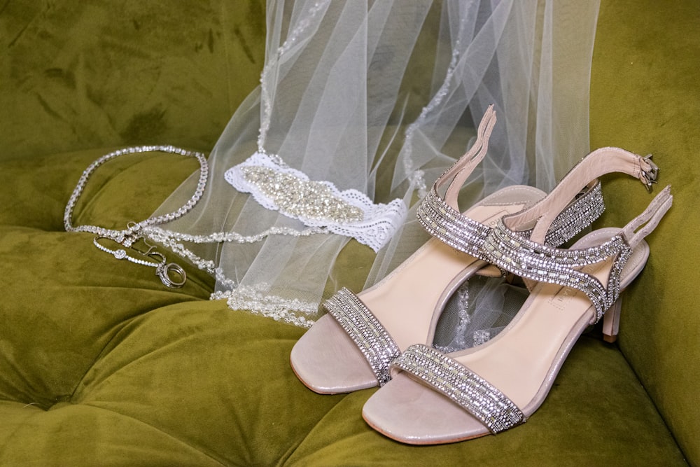 a pair of shoes and a veil on a couch