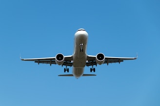 a large jetliner flying through a blue sky