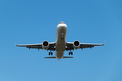 a large jetliner flying through a blue sky