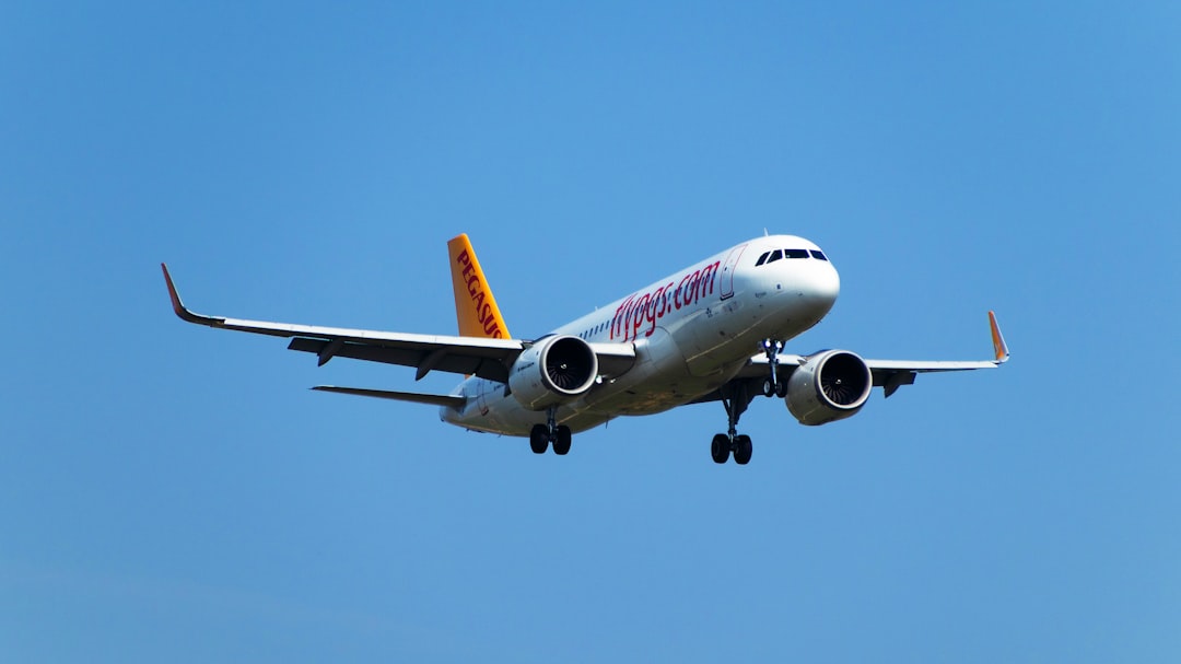 a large jetliner flying through a blue sky,
