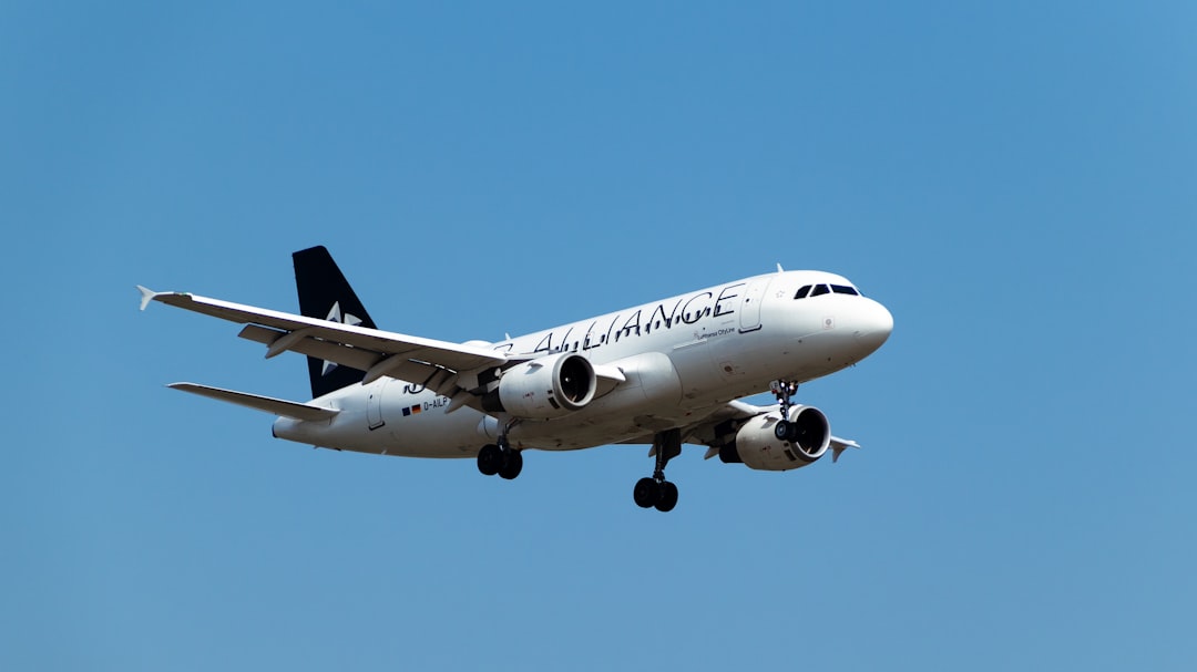 a large jetliner flying through a blue sky,