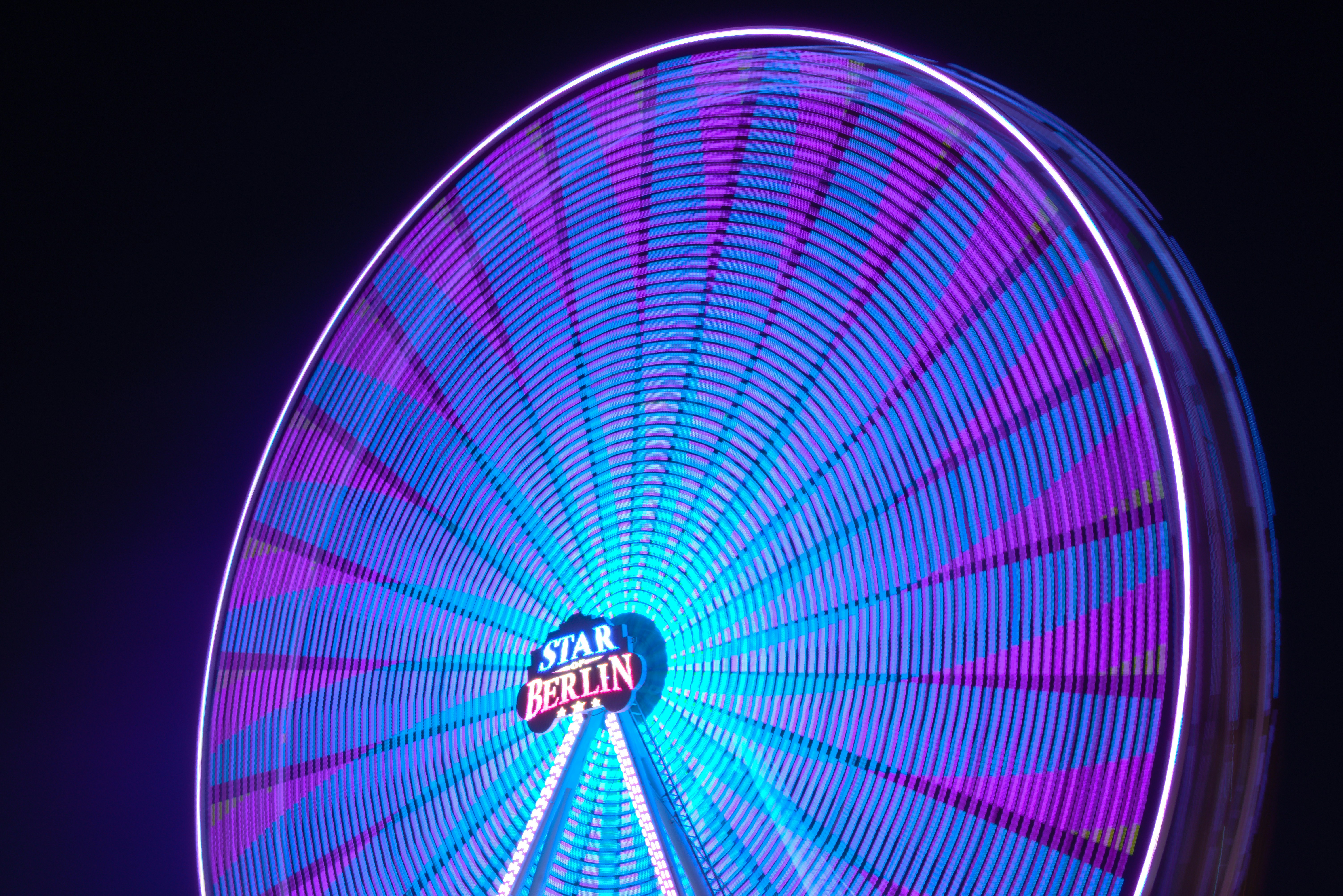 a brightly lit ferris wheel at a carnival