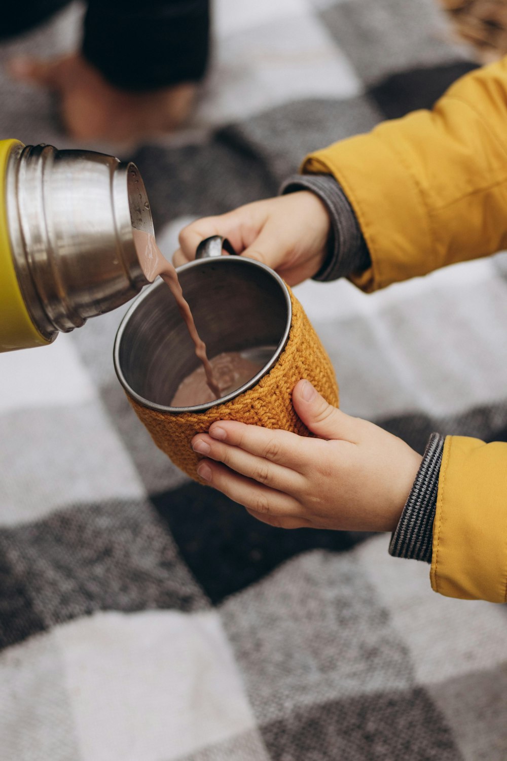 a person pouring something into a cup