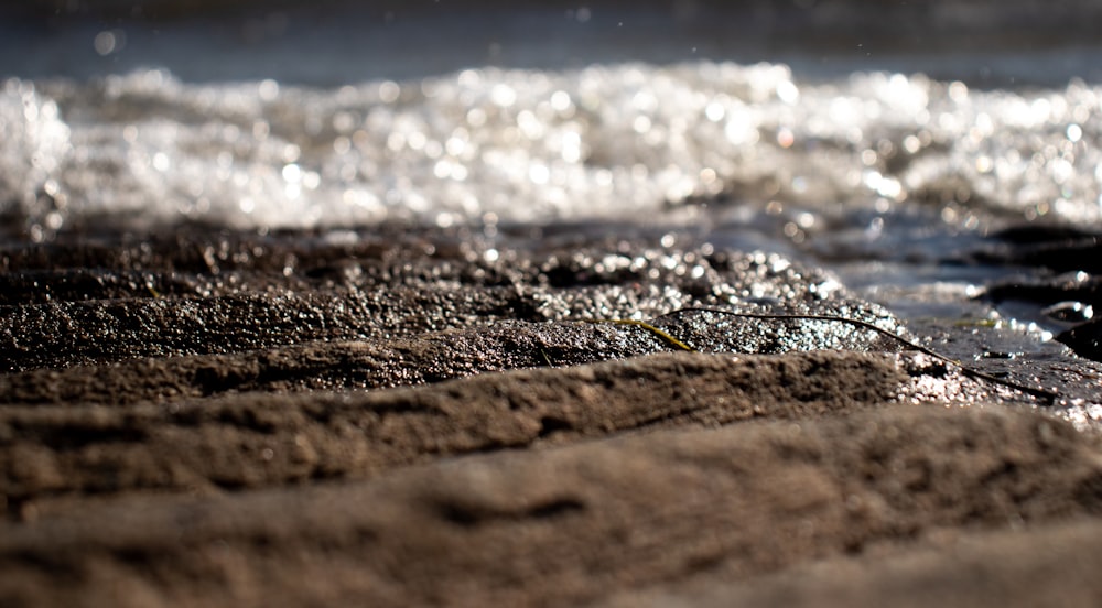 a close up of water and sand on a beach