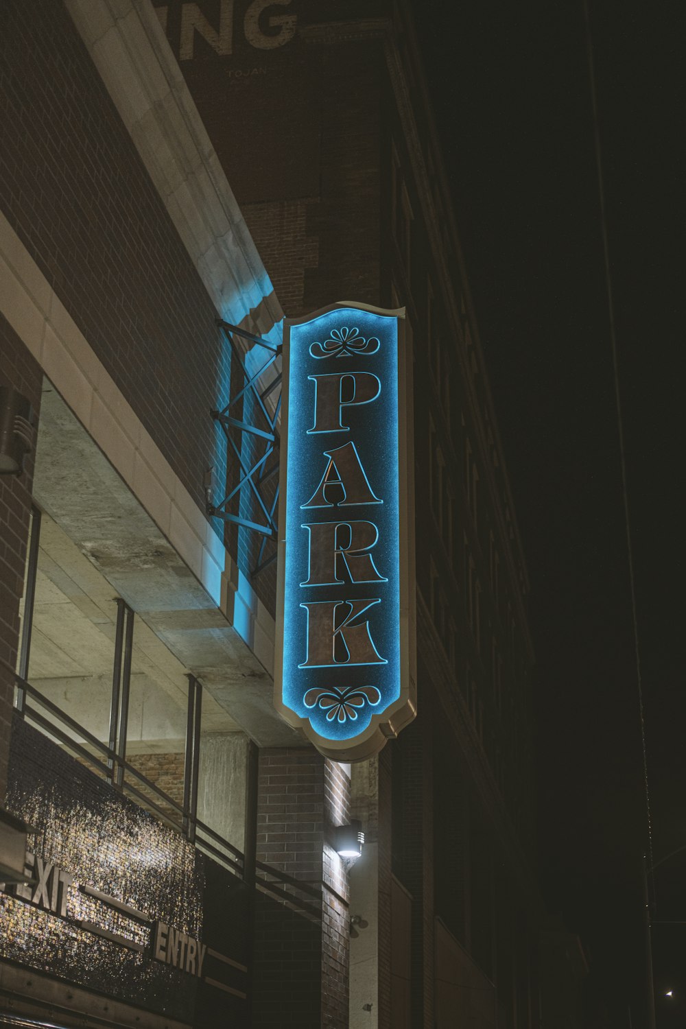 a neon sign that reads park on the side of a building