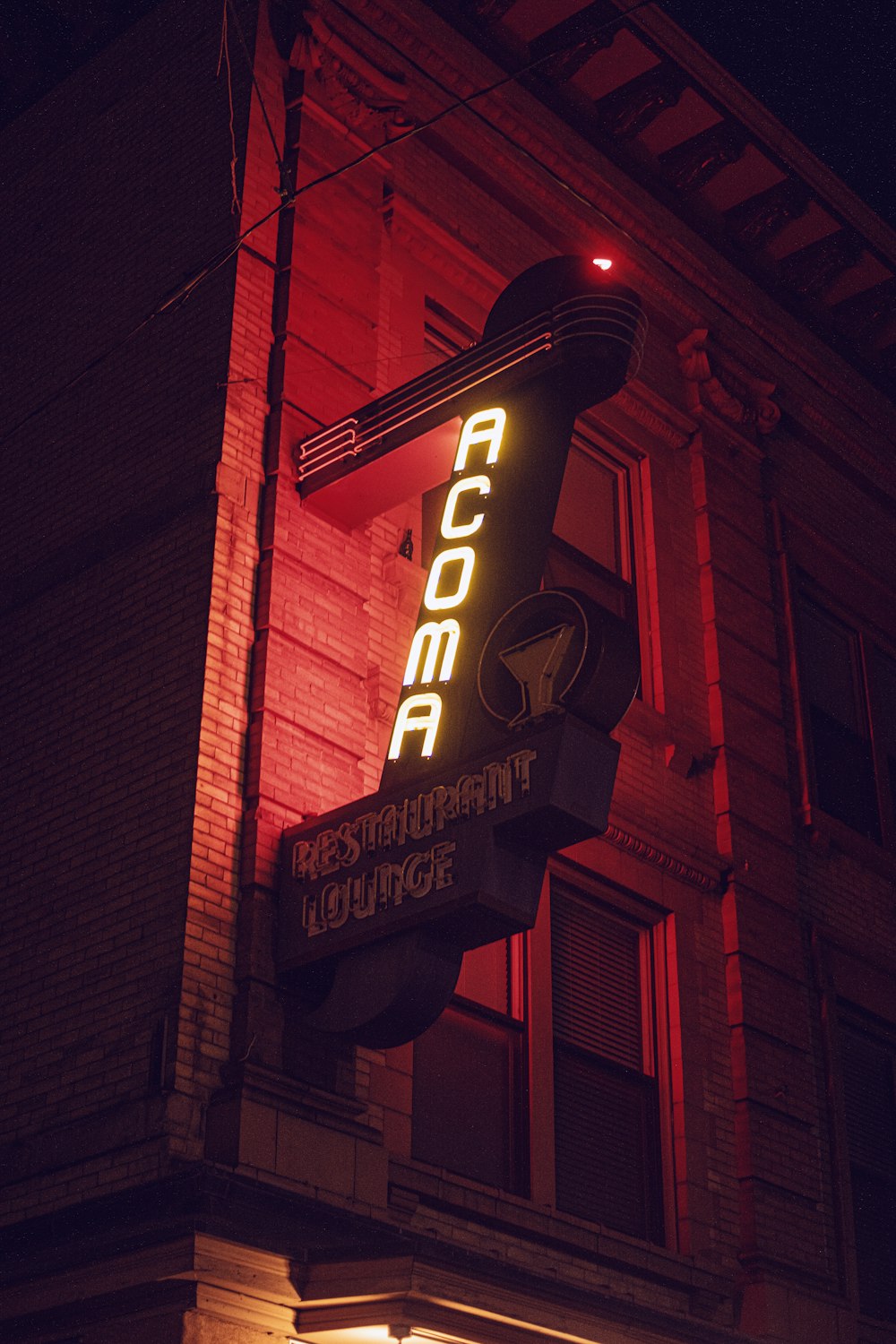 a neon sign on the side of a building