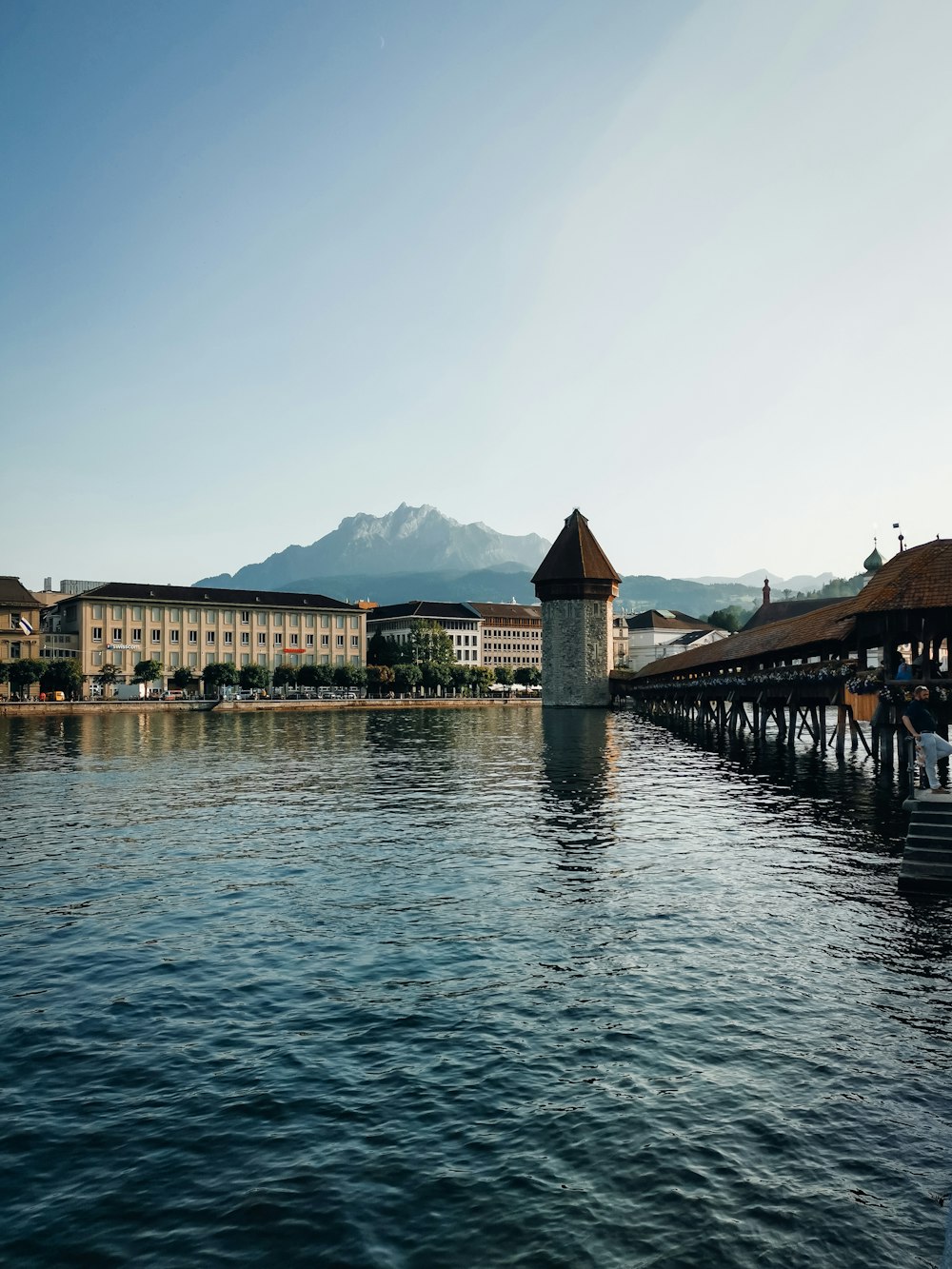 a large body of water with a building in the background