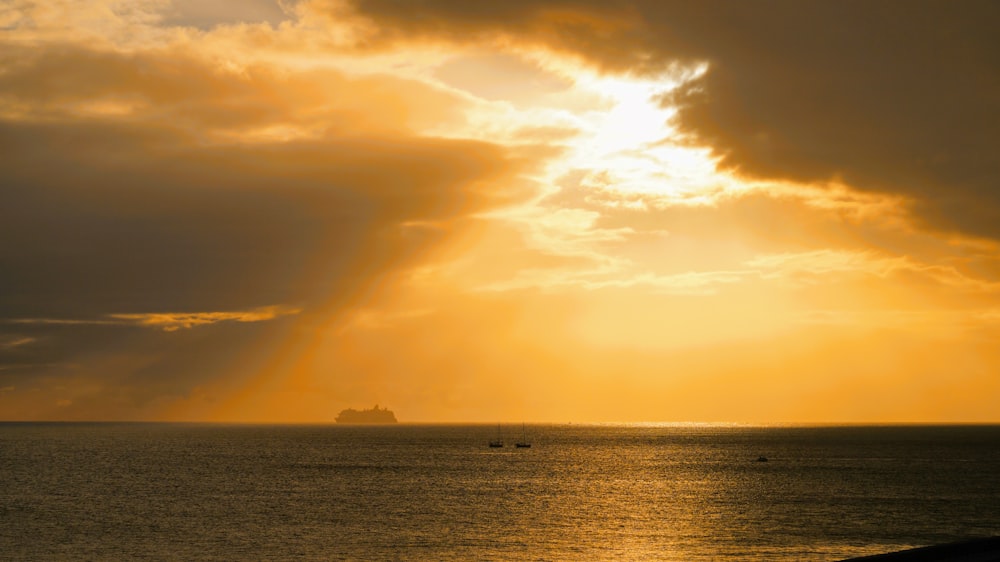 a large body of water under a cloudy sky