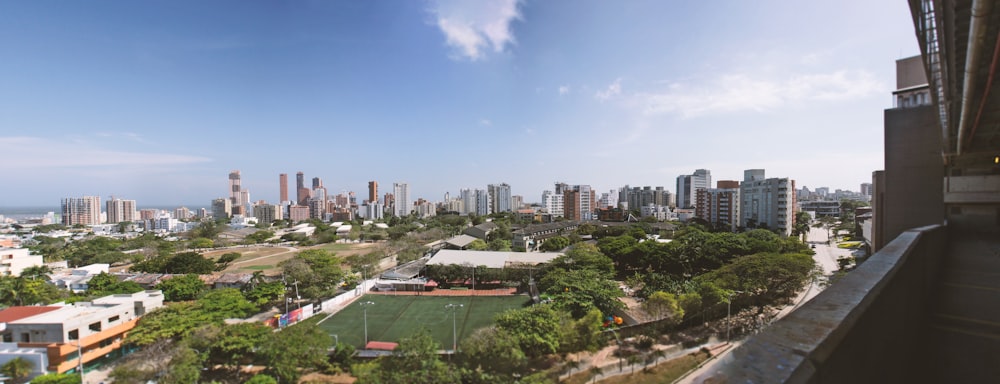 a panoramic view of a city with a soccer field
