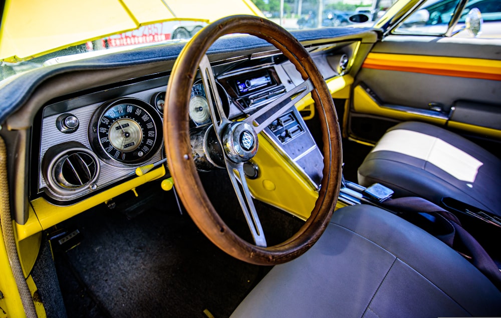 the interior of a car with a steering wheel and dashboard