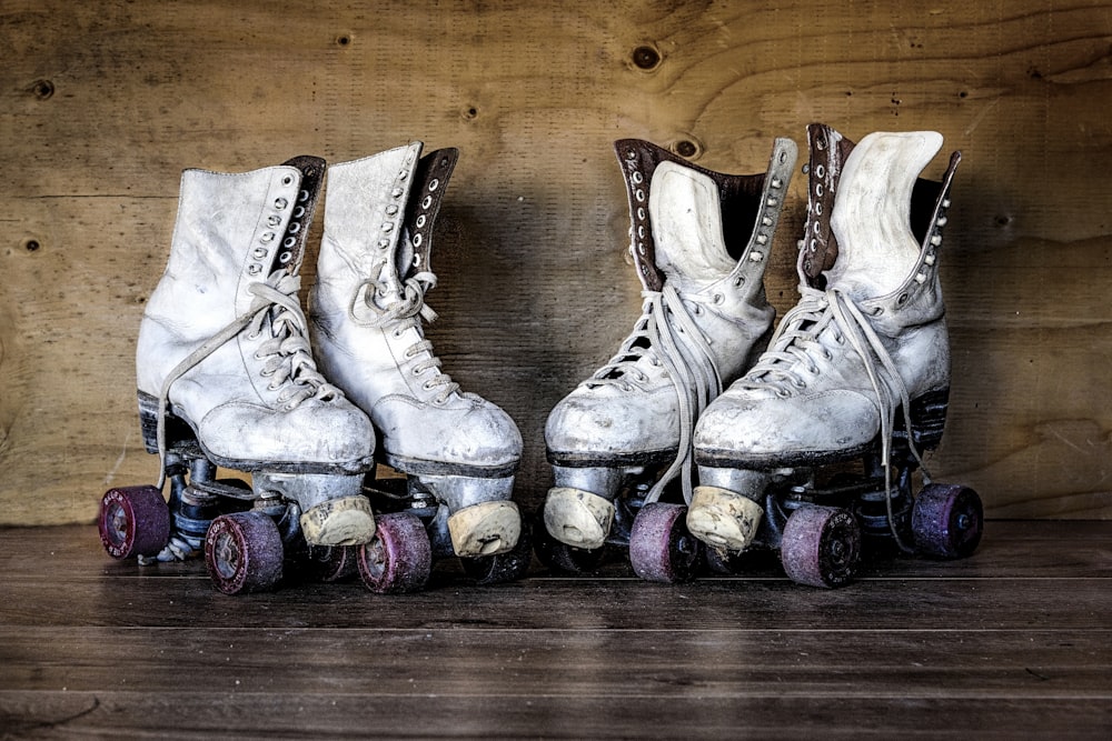 a couple of white skates sitting on top of a wooden floor