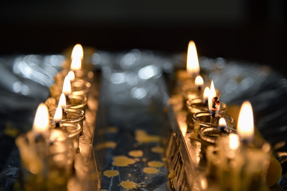 a group of lit candles sitting on top of a table