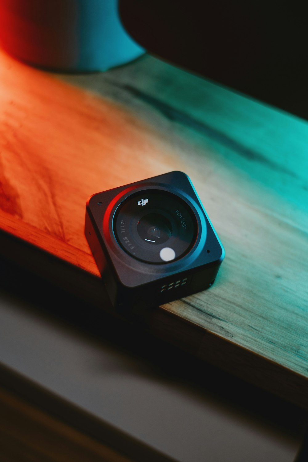 a camera sitting on top of a wooden table