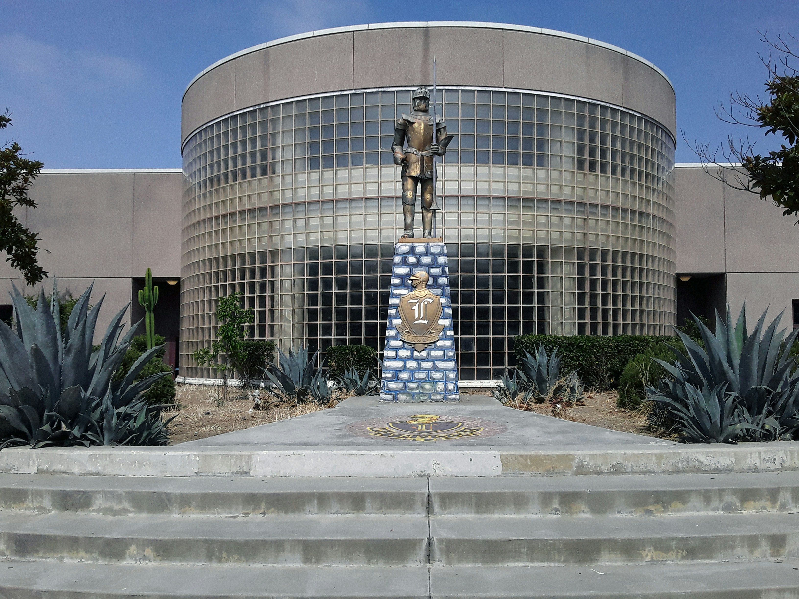 a large building with a statue in front of it