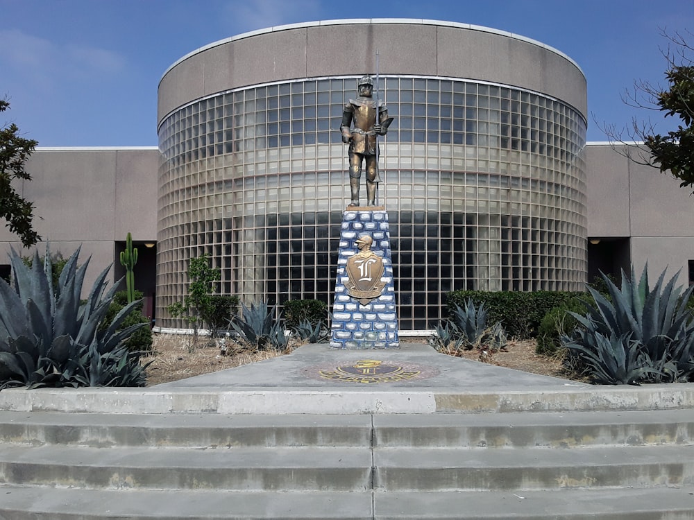 a large building with a statue in front of it