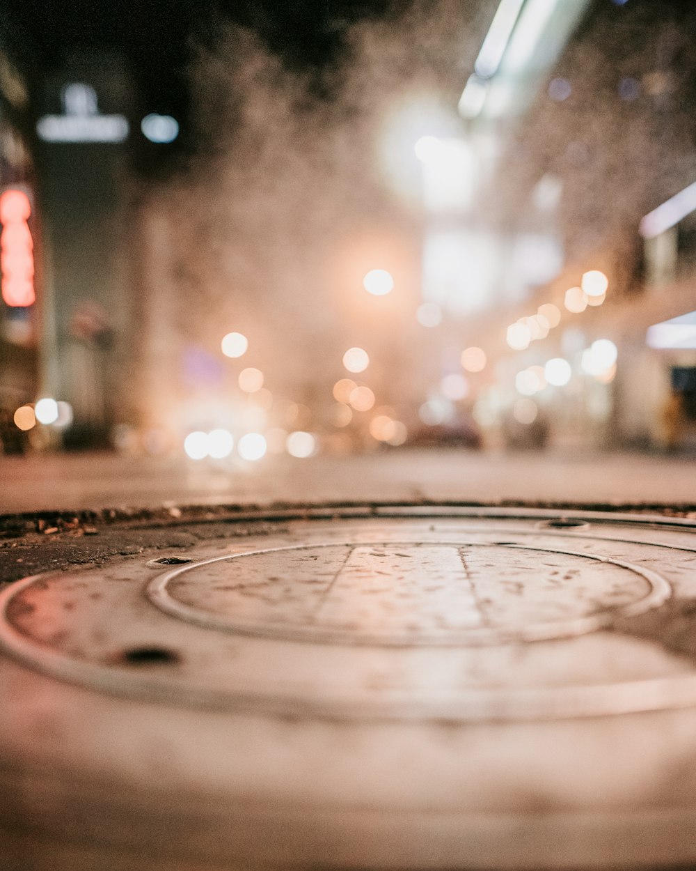 a manhole cover on a city street at night