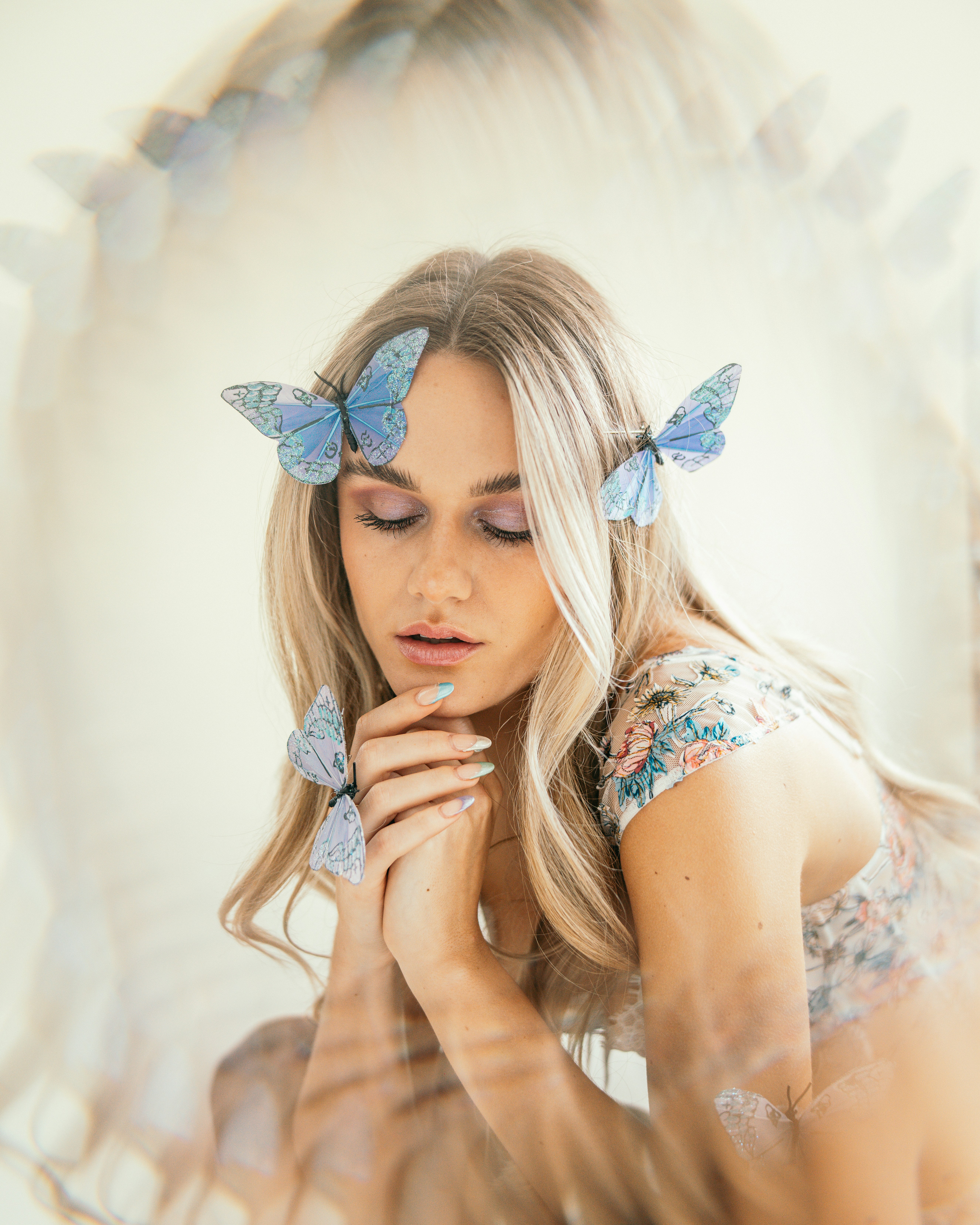 a woman with blue butterflies on her hair