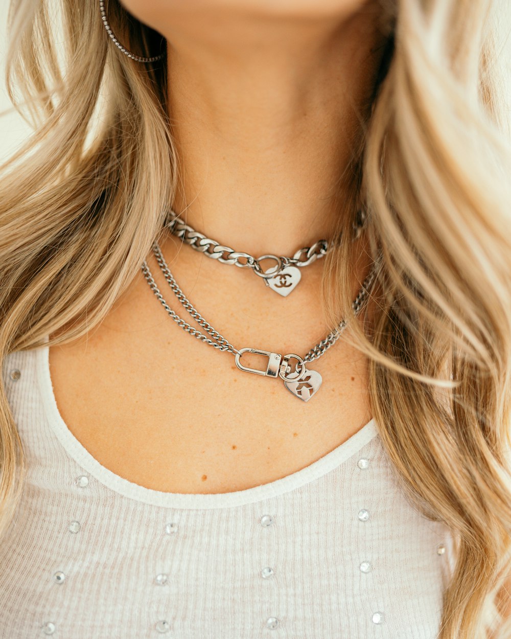 a close up of a woman wearing a necklace