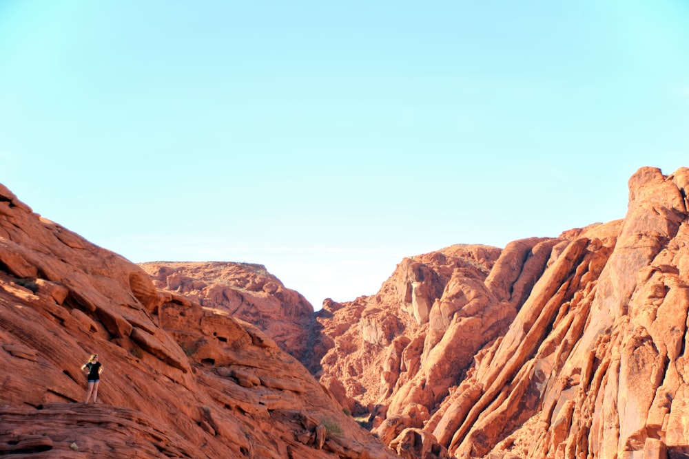 a person climbing up the side of a mountain