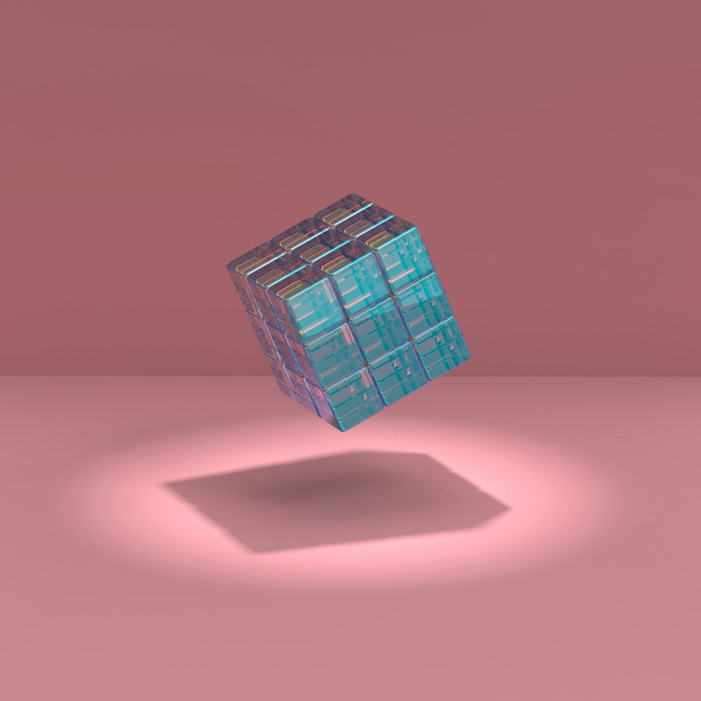 a blue cube sitting on top of a pink floor