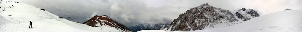 a man riding skis down a snow covered slope