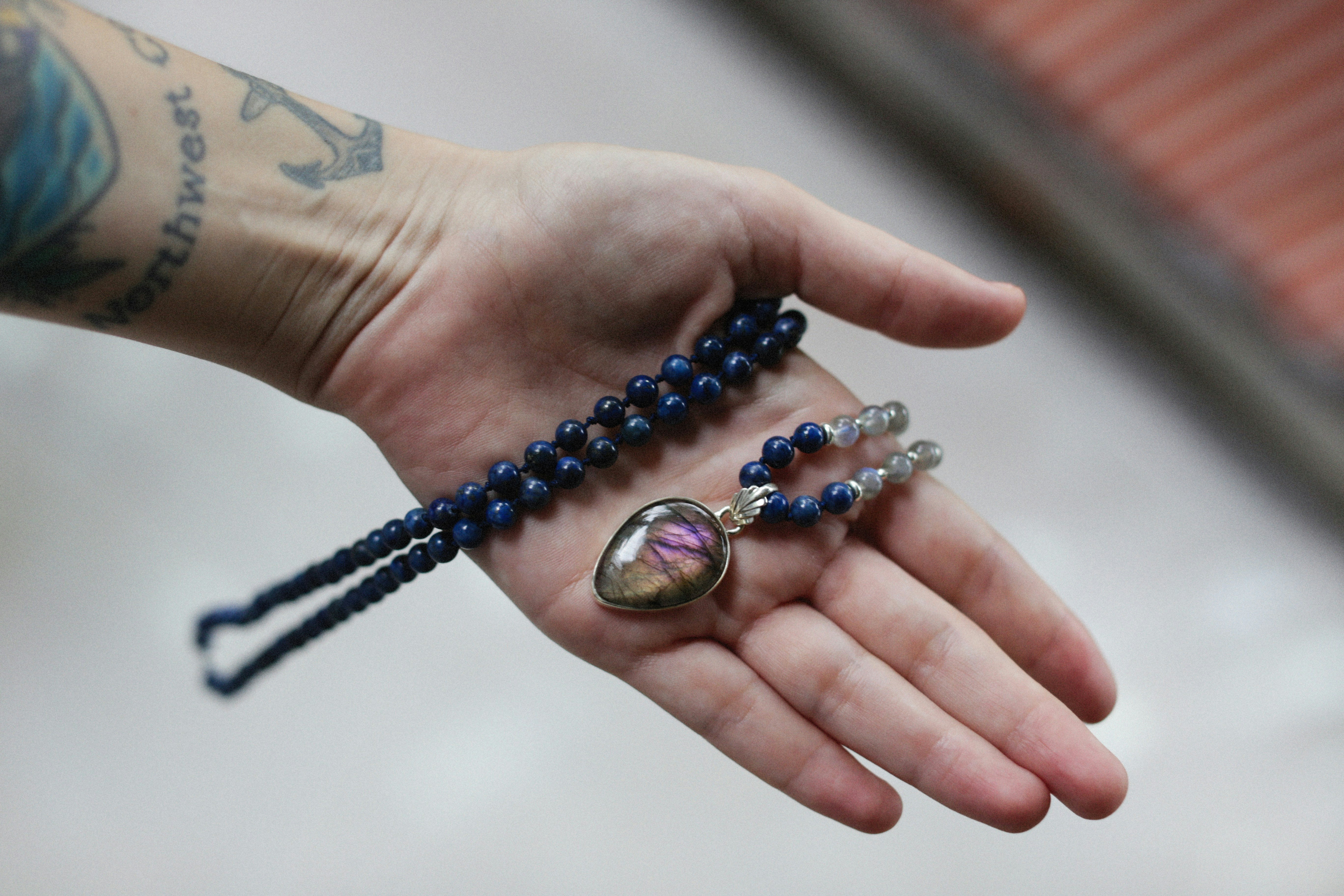a person holding a rosary with a picture on it