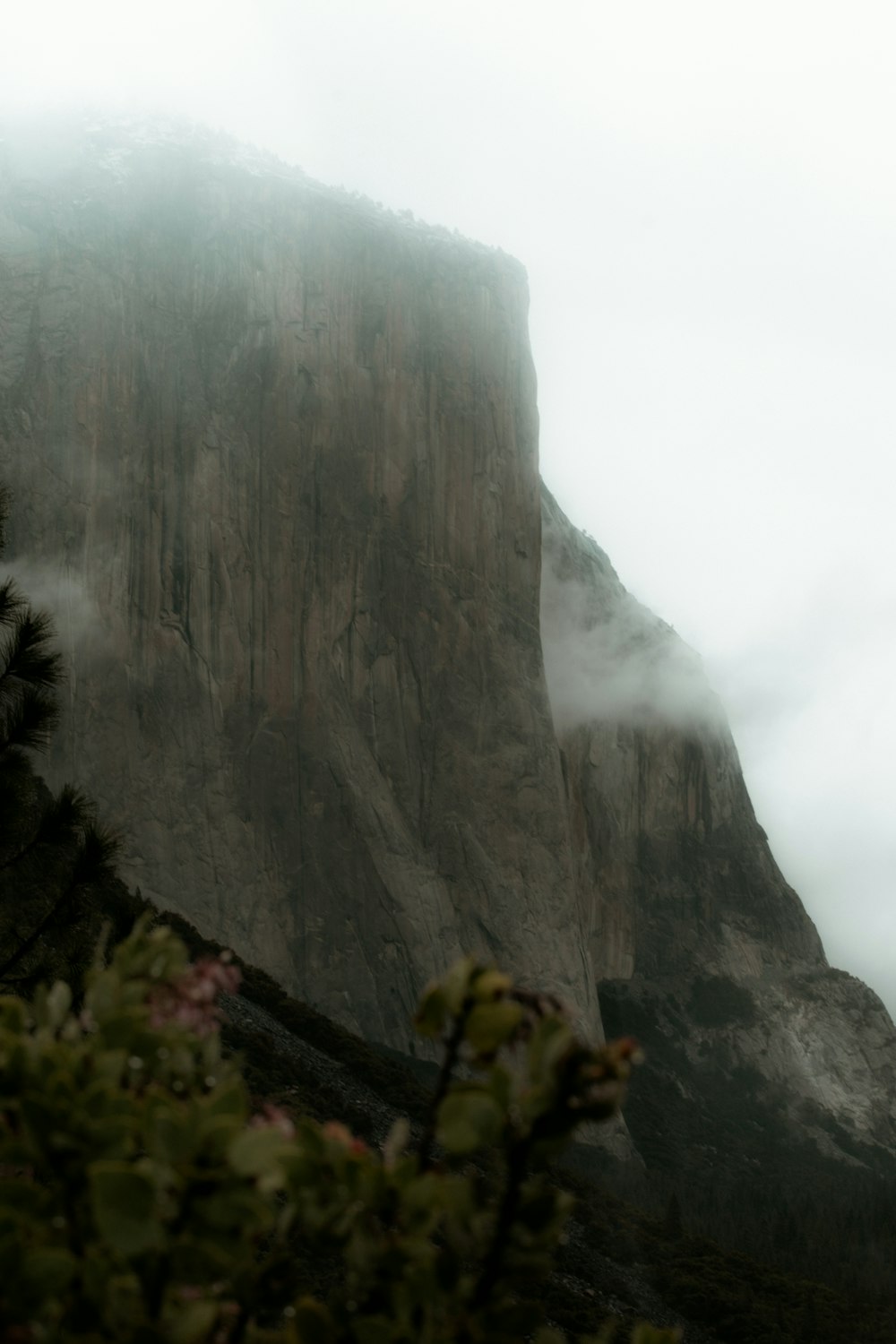 a tall mountain covered in fog and clouds