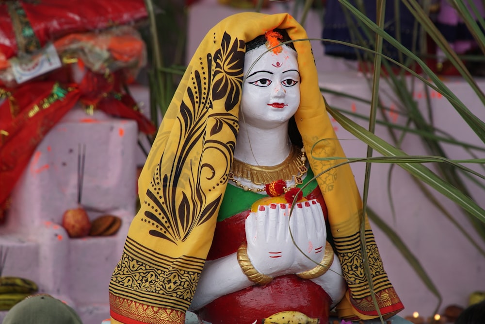 a statue of a woman with a yellow shawl