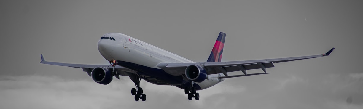 a large jetliner flying through a cloudy sky