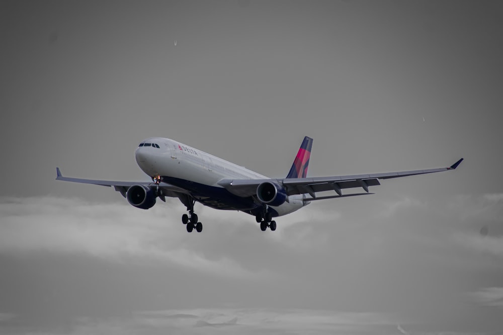 a large jetliner flying through a cloudy sky