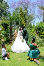 A beautiful wedding scene with a bride and groom surrounded by friends and family.