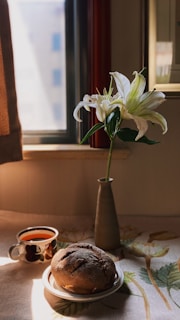 A simple breakfast scene with toast, fruit, and a cup of tea by a window.
